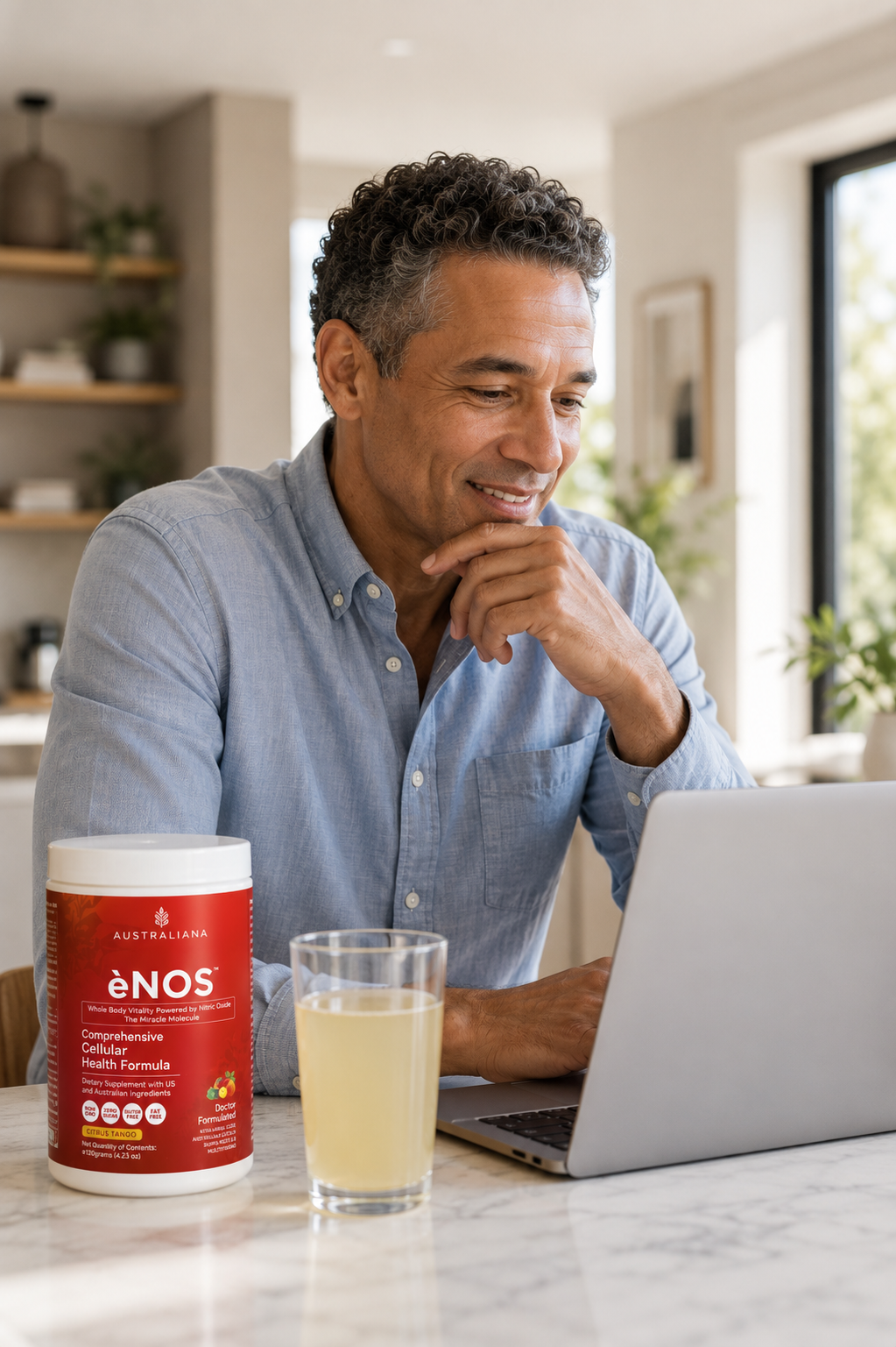 Man enjoying ėNOS while working on laptop